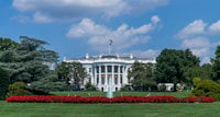 a white house with a flag on top with White House in the background